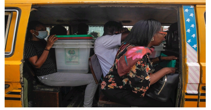 Electoral officers hired to distribute election material to polling units sit with ballot boxes in a popular Lagos informal transport system known as Danfo during the elections in Ikeja district, Lagos. Photograph by Akintunde Akinleye/CCIJ