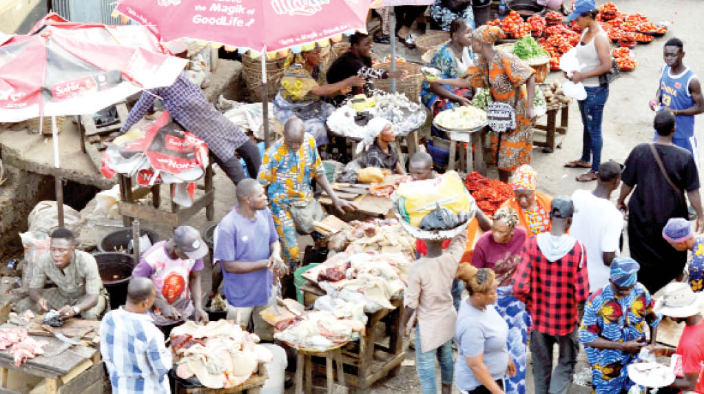 traders and customers at agege main market in lagos state, yesterday